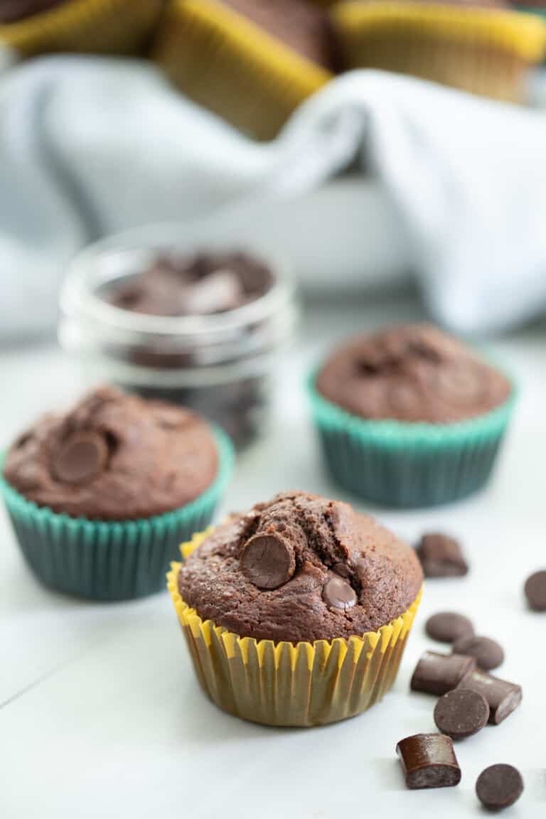 Three double chocolate chip muffins with chocolate chips